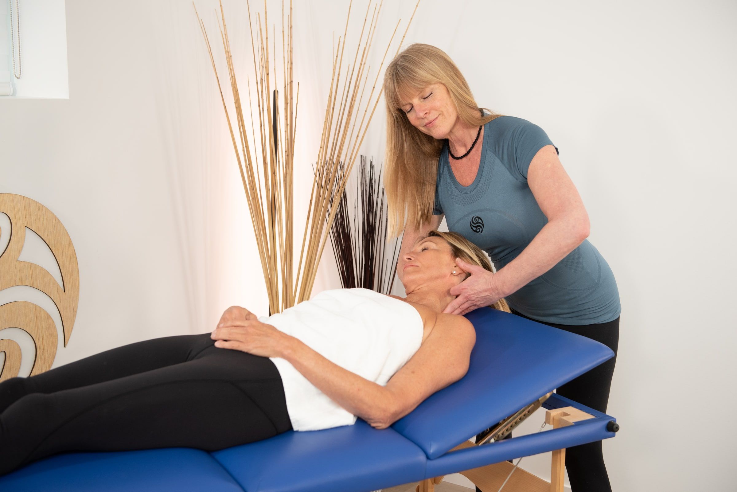 Deanna Hansen working hands-on with a client lying on a treatment table
